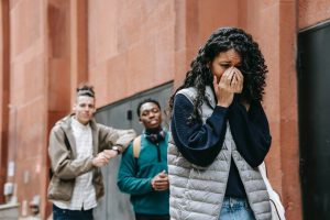 Young teen crying and walking away from guys. If you're looking for help for your anxious kids and teens, then consider online christian counseling for children or online Christian counseling for teens. Get help with a skilled online Christian therapist today in Chicago, Champaign, Huntley or anywhere in Illinois.