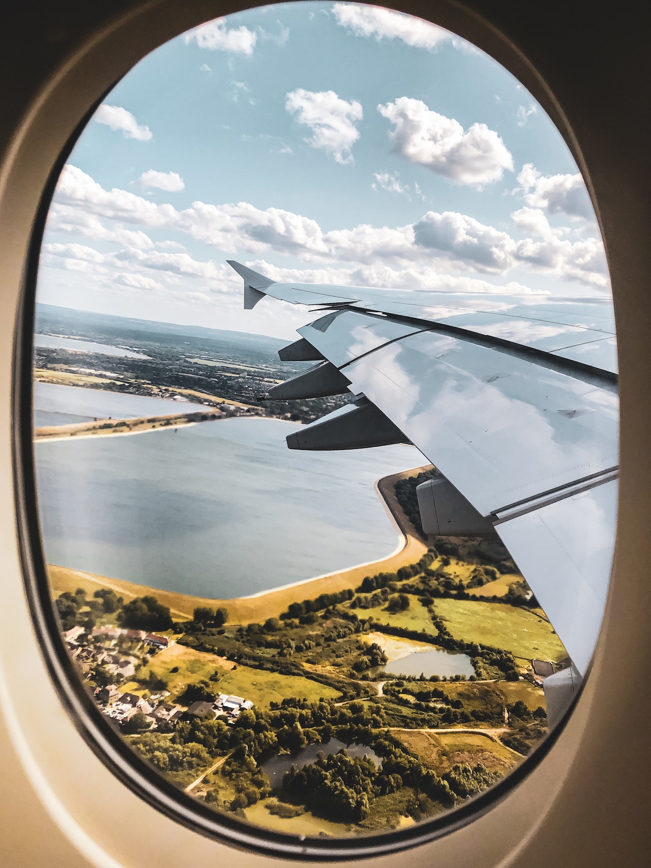 Photo of airplane wing through the view of an airline passenger looking out the small oval window. Photo could represent the anxiety a child might feel that far off the ground and the need for solution focused brief therapy for kids in Illinois or Florida.